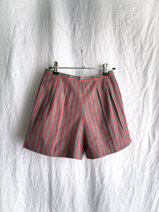 Front view of vintage 1940s French striped cotton shorts against a white wrinkled background