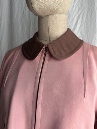 A close-up of a pink and brown garment  with a charming peter pan collar