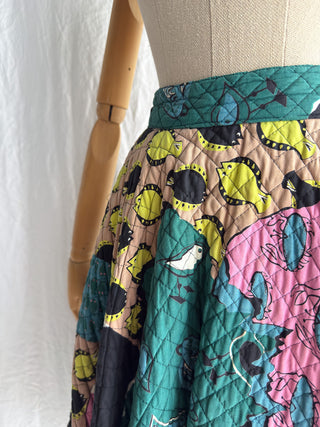 Detail of the waistband and the colorful patchwork print on a 1950s vintage skirt.