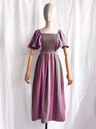 Front view of a vintage 1970s Rikma woven cotton dress displayed on a mannequin.