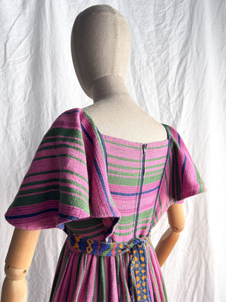 Detailed view of the bohemian 70s folk dress featuring wide angel sleeves and contrast trim.