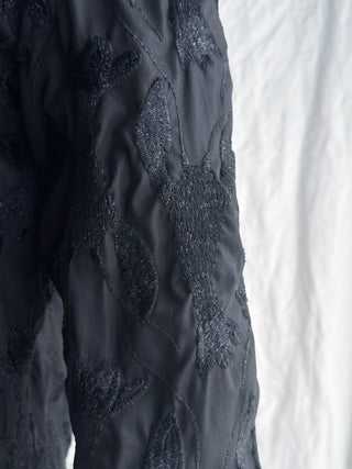 Close-up of the intricate black lobster embroidery on a black Franck Joseph Paris jacket.