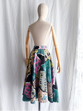 Back view of the full 1950s quilted cotton circle skirt showing the pattern continuity and volume.
