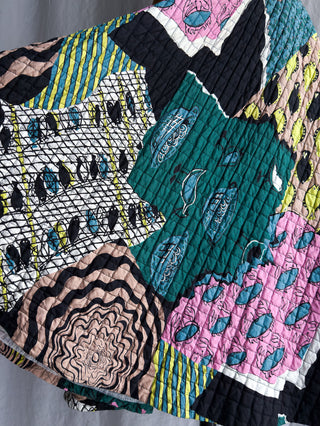 Close-up detail of the vintage novelty fish print fabric on the quilted cotton skirt.