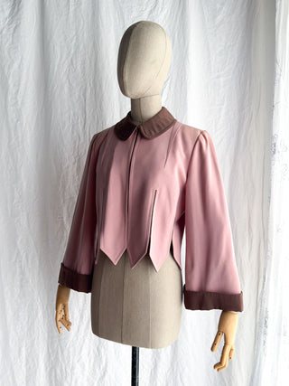 A pink and brown 40s jacket with dark brown trim on the collar, cuffs, and hem