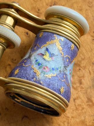 Macro close-up of the exquisite French enamel detailing depicting a small bird nestled among colorful flowers.