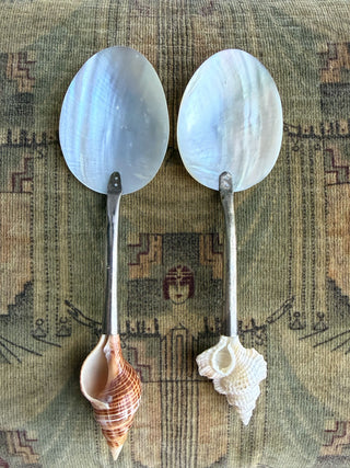 Two decorative spoons with mother-of-pearl oval heads and shell handles