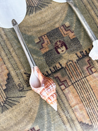 A close-up of the natural seashells on the handle of vintage spoons